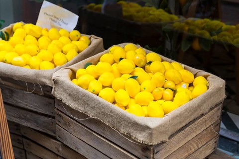 2 wooden boxes full of ripe, yellow lemons in Västerlånggatan in the old town of Gamla Stan,
