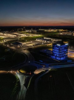 Aerial view of a brightly lit industrial building at night, Nagold, Black Forest, Germany
