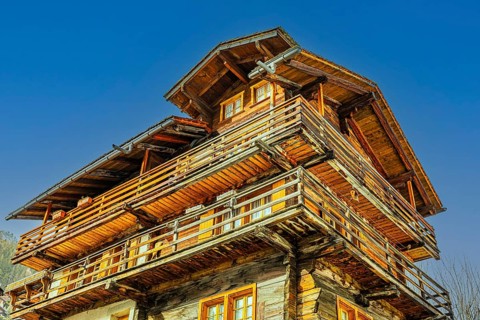 Multi-storey old farmhouse with surrounding balconies, historic town center, Grimentz, Val