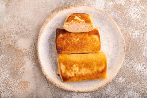 Fried crispy pancakes with meat and cheese on brown concrete background. top view, flat lay, close