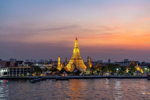 The Buddhist temple Wat Arun or Temple of Dawn and the Chao-Phraya River at dusk, Bangkok, Thailand