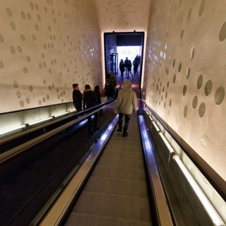 Young man on escalator, Elbphilharmonie concert hall, Hafencity, Hamburg, Germany