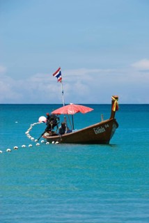 Typical Thai longtail boat on Bang Tao Beach in the northwest of the holiday island Phuket,