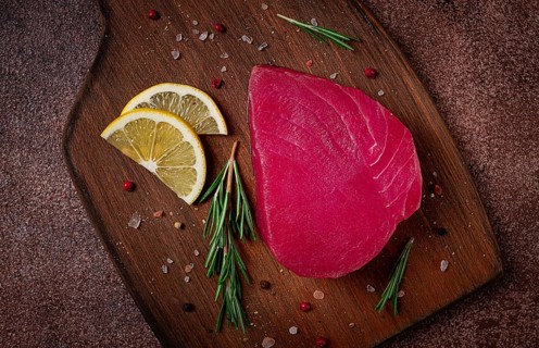 Fresh red tuna fillet, for steak, raw, top view, on a cutting board, no people