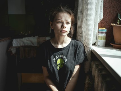 Alina, 15 years old, in the kitchen of the flat where she lives with her siblings, her mother and