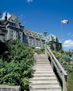 Stairs leading to Manoir Richelieu facade with landscaped frontyard in summer, Charlevoix, Quebec,