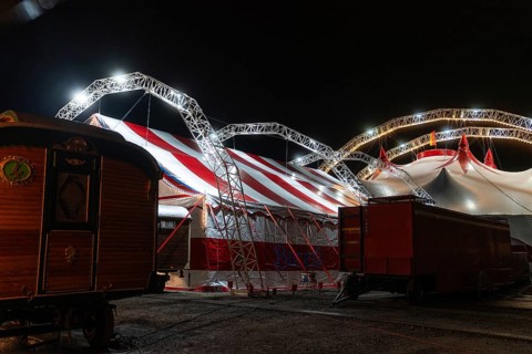 Backyard of a circus with illuminated circus tent and wagon, Böblingen, Germany