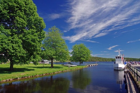 River landscape with boats and tall trees under a clear sky, Haverud, Dalsland Canal, Dalsland,