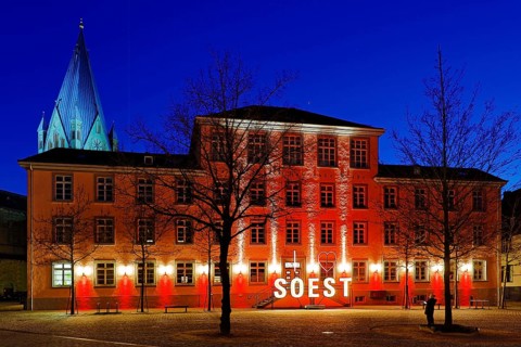 Illuminated town hall with St Patrokli Cathedral in the evening at the Winter Radiance Festival of