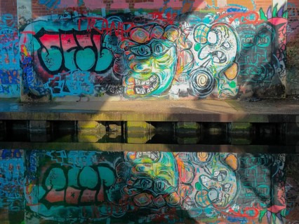 Grafitti under the city railway bridge at Linderner harbour, lock, canal, reflection, Hanover,