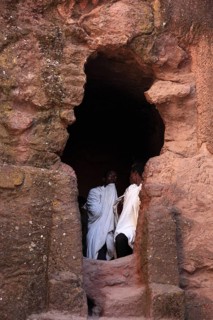 Rock churches of Lalibela, pilgrims stand at the entrance to the symbolic tomb of Adam, Ethiopia