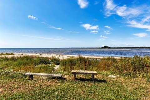 Quiet coastal landscape on the Baltic Sea, simple benches with views of sandy beach, Cirrus in
