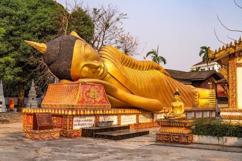 Giant reclining Buddha at Wat That Khao temple in the capital Vientiane, Laos