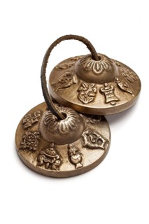 Tibetan Buddhist tingsha cymbals isolated on white
