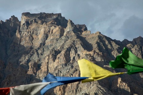 Mountain range in Spiti Valley, India, adorned with vibrant prayer flags fluttering in the wind