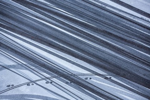 Car tire tracks and footprints in fresh snow, Schöneberg, Berlin, Germany