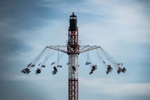 Giant Nordic Tower chain carousel on the summer DOM 2026 against slightly cloudy sky, Hamburg,