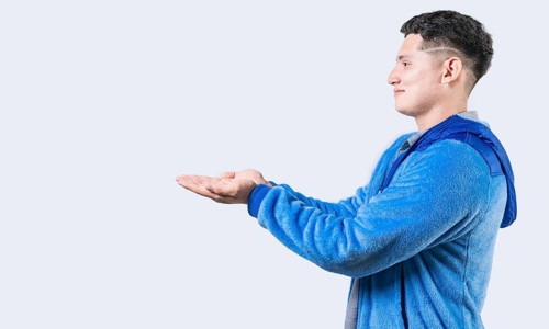 Smiling person showing something with palms together. Guy showing something with palms together