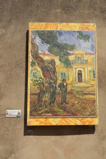 Painting replica pine and figure in front of Saint-Paul-de-Mausole church by Vincent van Gogh,