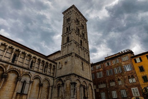 Dark rain clouds over the bell tower of the church of San Michele in Foro, historic city centre,