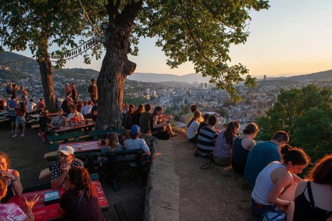 Sarajevo, Bosnia. July 25th 2019 Tourists watch the sunset from the terrace of the Park Princeva
