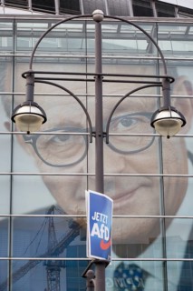 An election poster of the far-right AfD party (now AfD) hangs in front of a portrait of Friedrich