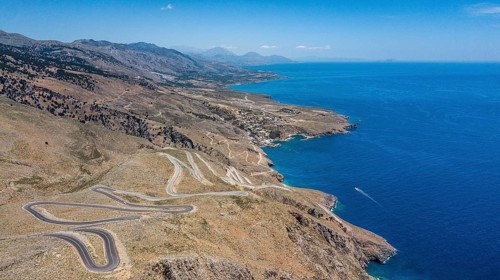 Aerial view of pass road serpentines from to Passo Anopoli above south coast of Crete right Libyan