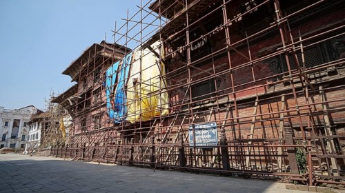 Historic buildings with scaffolding secured by support beams in Kathmandu, Durbar Square, shortly