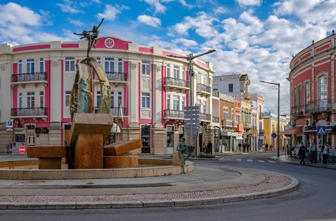 Loule, Algarve, Portugal - Houses with colourful facades in the old town of Loulé, roundabout with