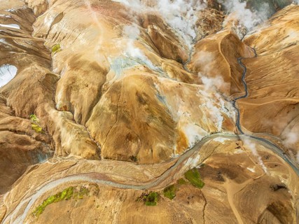 Steaming hot springs and colourful rhyolite mountains, aerial view, Hveradalir geothermal area,
