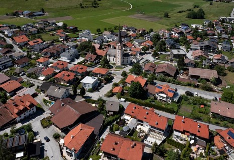 Drone shot, view of the village with parish church, Rinn, Tyrol, Austria
