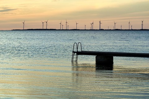 Seaside jetty, bathing area, wind farm on the horizon, sunset, back light, Baltic Sea, Burgsvik,