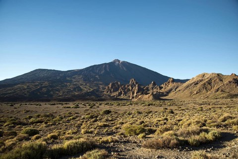 Ucanca plain, behind it Roques de Garcia, lava rock formations and Pico del Teide, 3718m, Parque