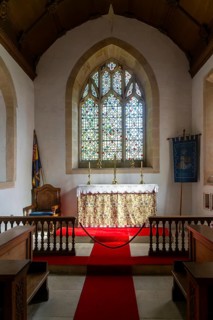 Interior view of east window and altar, church of Saint Michael, Yanworth, Gloucestershire,