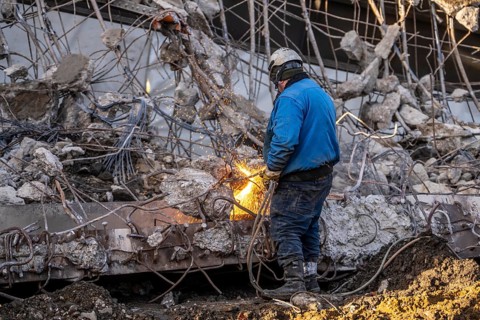 Workers with cutting torches demolishing the 120-meter long motorway bridge of the A516, across