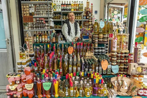 Stall with liqueurs, schnapps, honey and olive oil at the market in Trogir, Croatia