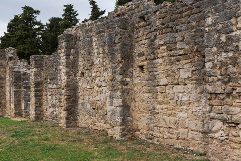 Long old stone wall structure at ancient 3rd century Roman ruins of Salona near Solin in late