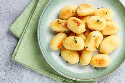 Stuffed gnocchi with cheese, Italian dumplings, garnished with parmesan cheese, no people