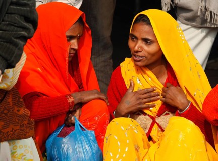 New Delhi, India, 15.01.10 - Two woman wearing traditional Indian clothes wait at the train