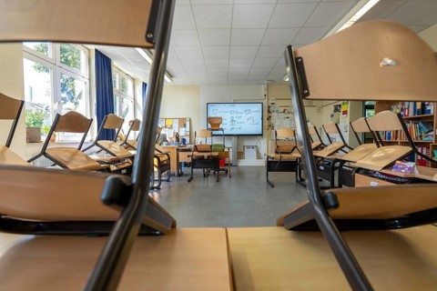 Classroom of a fourth grade, after school, the building is older but in good condition, modern