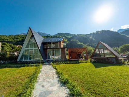Wooden houses and hotels in the valley of Theth national park, Albania. Albanian Alps