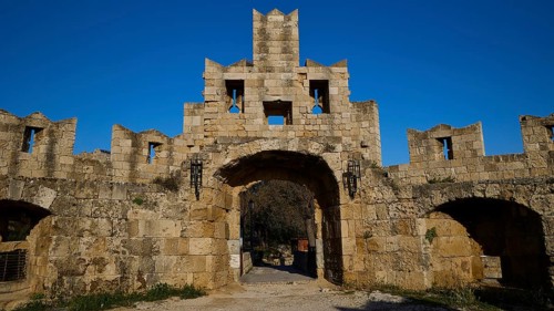 St Paul's Gate, entrance gate of a medieval castle with stone facade and blue sky, harbour area,