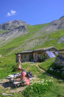Woman enjoying a coffee break at the Chalet refuge de Chamoissiére, Villar-d'Arêne, Département