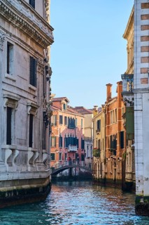 View from 'Canal Grande' on bridge going over a waterway 'Rio san luca' in Venice on a sunny day in