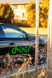 Black electric car in a natural environment with trees, Deer E- Carsharing vehicle MG4, Calw