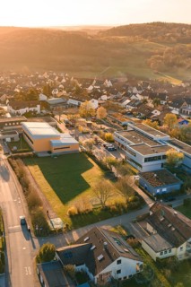 Suburban landscape with buildings and roads from a bird's eye view at sunset, Schlehengäuschule,