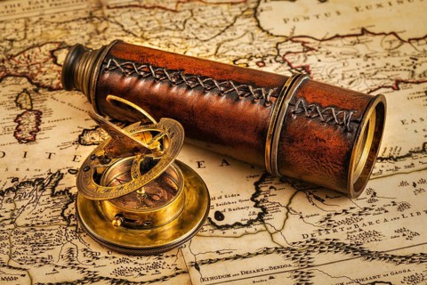 Travel geography navigation concept background, old vintage retro compass with sundial and spyglass