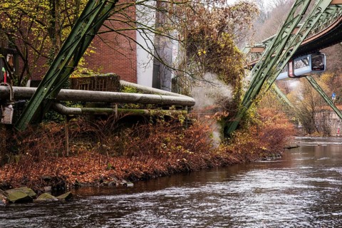 District heating pipeline in front of old industrial buildings on the banks of the Wupper,