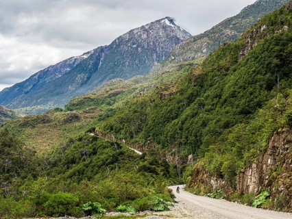 Bicyclist on road Carretera Austral, north of Puerto Yungnay, Patagonia, Chile
