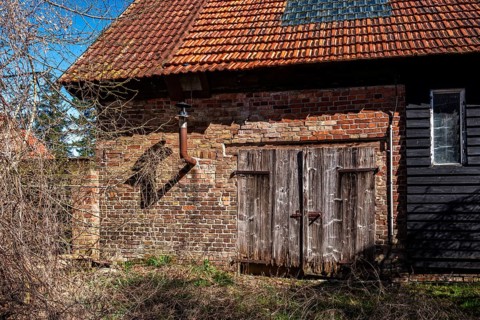 Abandoned and derelict farmhouses on undeveloped land in Rügen, Mecklenburg-Vorpommern, Germany